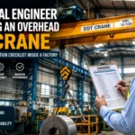 Professional engineer performing an annual EOT crane inspection inside an industrial manufacturing facility